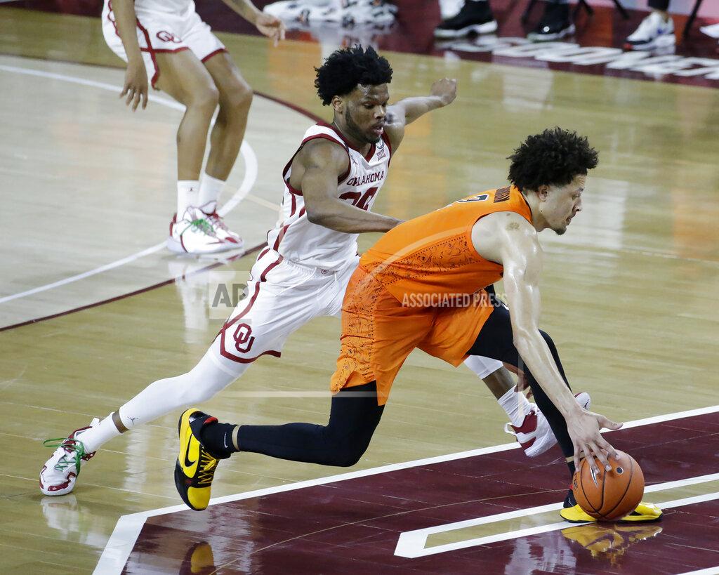 Garett Fisbeck Oklahoma State guard Cade Cunningham (2) goes against Oklahoma guard Elijah Harkless (24) during the second half of an NCAA college basketball game, Saturday, Feb. 27, 2021, in Norman, Okla. (AP Photo/Garett Fisbeck)