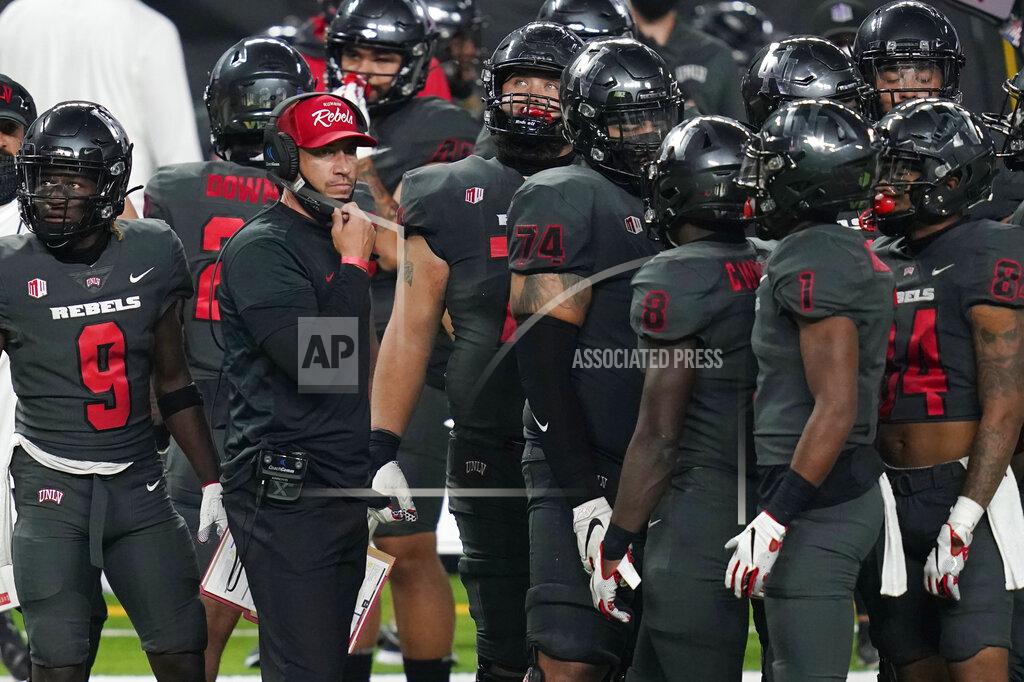 John Locher UNLV head coach Marcus Arroyo speaks with his players during the second half of an NCAA college football game against Nevada Saturday, Oct. 31, 2020, in Las Vegas. (AP Photo/John Locher)