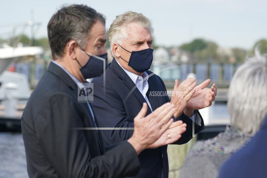 Steve Helber Virginia Gov. Ralph Northam, left, applauds speakers with former Gov. and Democratic gubernatorial candidate, Terry McAuliffe, right, during a news conference at Waterside in Norfolk, Va., Thursday, April 8, 2021. Northam endorsed McAuliffe for governor. (AP Photo/Steve Helber)