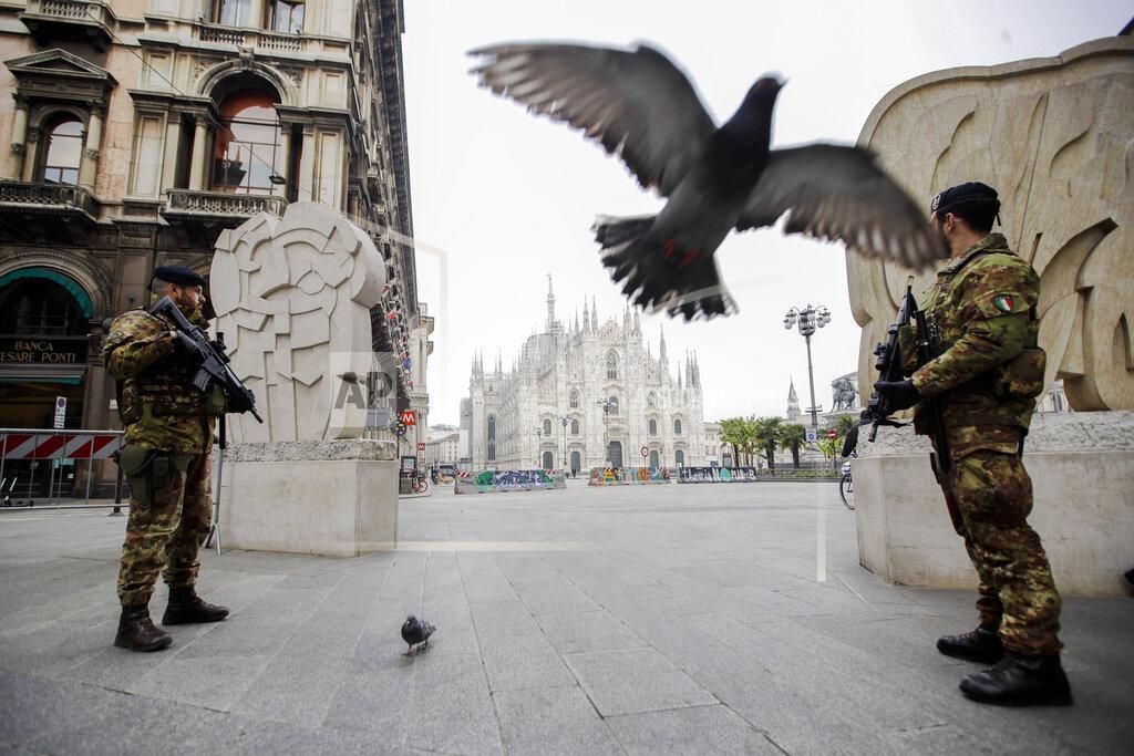 Luca Bruno Soldiers patrol Milan, Italy, on Friday, March 20, 2020, with the Duomo gothic cathedral in the background. Mayors of many towns in Italy are asking for ever more stringent measures on citizens' movements to help contain the surging infections of the coronavirus. (AP Photo/Luca Bruno)
