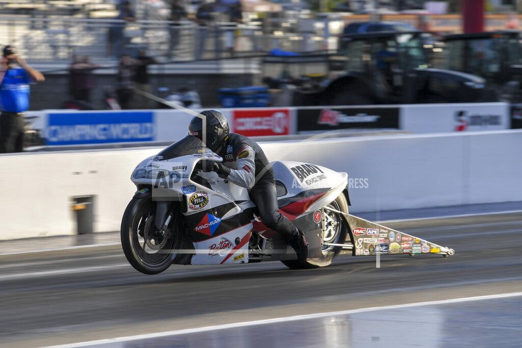 Richard H Shute In this photo provided by the NHRA, Pro Stock Motorcycle points leader Steve Johnson races to the provisional No. 1 position in his first-round qualifying run on his Mac Rak/Slick 50 Suzuki at the DeWalt NHRA Carolina Nationals at zMAX Dragway in Concord, N.C., Friday, Sept. 17, 2021. (Richard H. Shute/NHRA via AP)