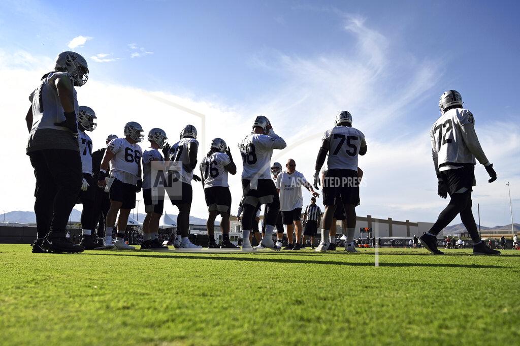 David Becker The Las Vegas Raiders offensive line runs drills during an NFL football practice Saturday, July 31, 2021, in Henderson, Nev. (AP Photo/David Becker)