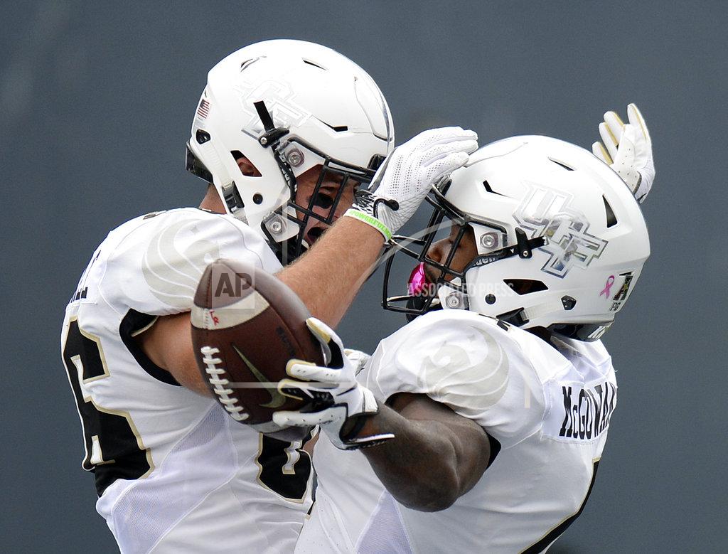 Mark Zaleski Central Florida running back Taj McGowan, right, celebrates with tight end Michael Colubiale (86) after McGowan scored a touchdown on a 2-yard run against Memphis during the first half of an NCAA college football game Saturday, Oct. 13, 2018, in Memphis, Tenn. (AP Photo/Mark Zaleski)