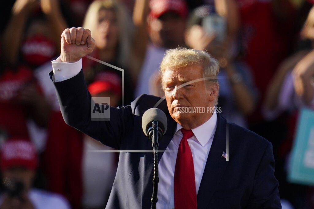 President Donald Trump pumps his fist after speaking at a campaign rally at Phoenix Goodyear Airport Wednesday, Oct. 28, 2020, in Goodyear, Ariz. (AP Photo/Ross D. Franklin)