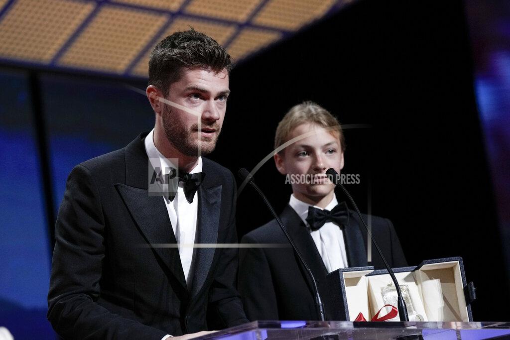 Joel C Ryan Director Lukas Dhont, left, and Eden Dambrine accept the grand prize for 'Close' during the awards ceremony of the 75th international film festival, Cannes, southern France, Saturday, May 28, 2022. (Photo by Joel C Ryan/Invision/AP)