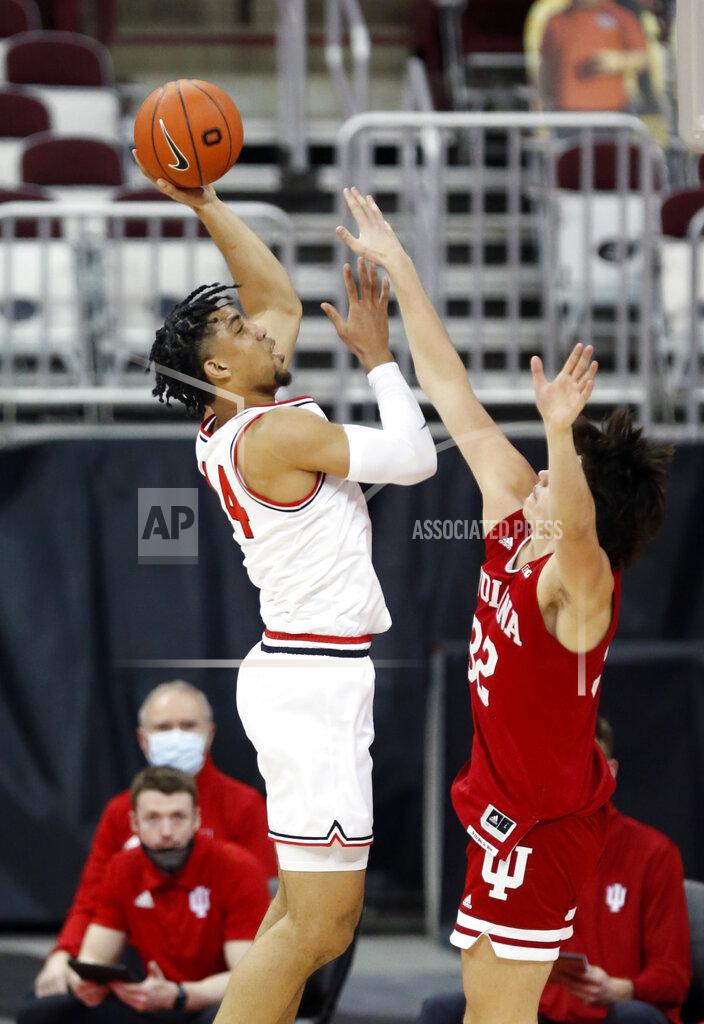 Paul Vernon Ohio State forward Justice Sueing, left, goes up for a shot against Indiana guard Trey Galloway during the first half of an NCAA college basketball game in Columbus, Ohio, Saturday, Feb. 13, 2021. (AP Photo/Paul Vernon)