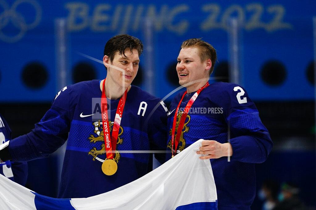 Matt Slocum Finland's Atte Ohtamaa, center, and Ville Pokka (2) celebrate after winning the men's gold medal hockey game at the 2022 Winter Olympics, Sunday, Feb. 20, 2022, in Beijing. Finland defeated Russian Olympic Committee 2-1. (AP Photo/Matt Slocum)
