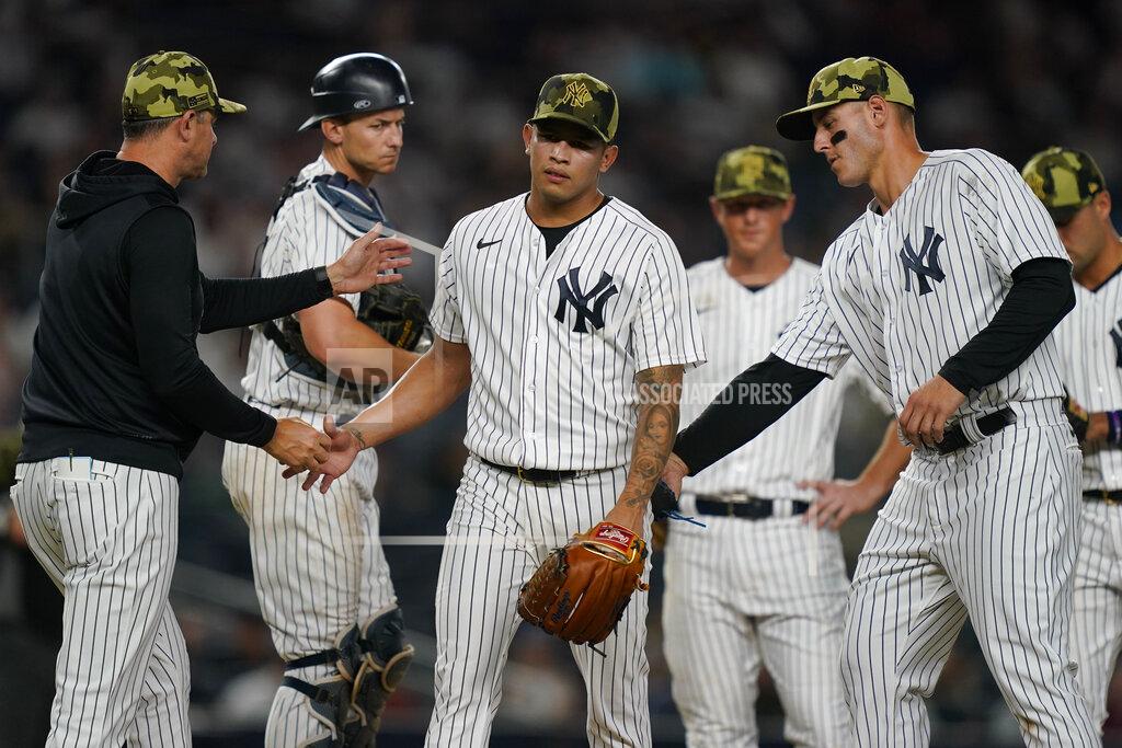 John Minchillo New York Yankees relief pitcher Jonathan Loaisiga, center, is relieved after giving up two runs in the eighth inning of the second baseball game of a doubleheader against the Chicago White Sox, Sunday, May 22, 2022, in New York. (AP Photo/John Minchillo)