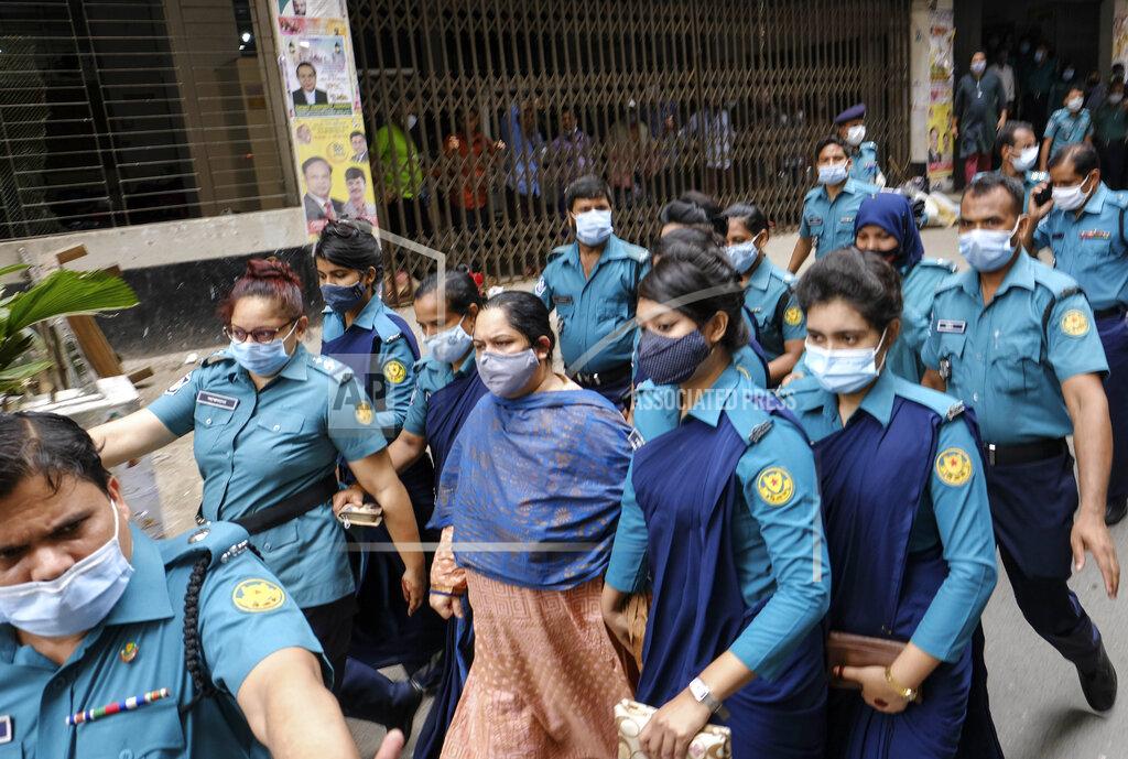 Mahmud Hossain Opu Bangladeshi journalist Rozina Islam, center, is escorted by police to a court in Dhaka, Bangladesh, Tuesday, May 18, 2021. Police in Bangladesh's capital have arrested the prominent journalist on charges of stealing and photographing sensitive state information. (AP Photo/Mahmud Hossain Opu)