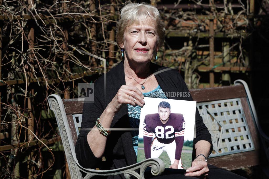 Tony Dejak Donna Houston holds up a photograph of her husband, Jim, during his playing years with the Cleveland Browns, Friday, April 3, 2020, in Sagamore Hills, Ohio. Houston's widow would keep notes on her husband's deteriorating condition in a three-ring binder so she would be prepared for the day when he needed full-time care. (AP Photo/Tony Dejak)