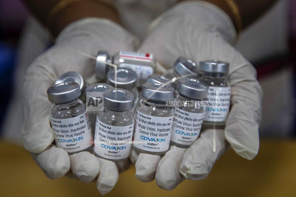 Anupam Nath FILE - In this May 8, 2021, file photo, a health worker displays empty vials of COVID-19 vaccines in Gauhati, India. The disparities of the coronavirus pandemic were already stark in India, where access to health care is as stratified and unequal as other parts of its society. Now, the divide along the lines of wealth and technology are further widening that chasm, and many people are falling through the gaps as vaccines remain inaccessible to millions. (AP Photo/Anupam Nath, File)