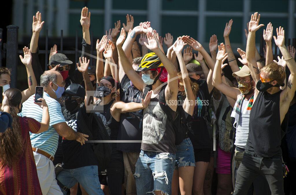 Chris Granger New Orleans Renters Rights Assembly protesters hold their hands in the air as they block people, left, from entering First City Court near New Orleans City Hall on Thursday, July 30, 2020 (Chris Granger/The Advocate via AP)