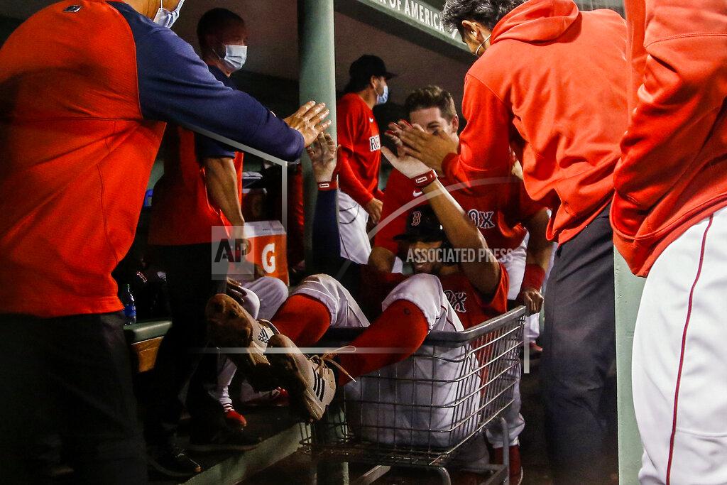 Winslow Townson Boston Red Sox's Xander Bogaerts goes for a ride in a shopping cart as he is congratulated by teammates after hitting a three-run home run against the Toronto Blue Jays during the fourth inning of a baseball game Tuesday, April 20, 2021, at Fenway Park in Boston. (AP Photo/Winslow Townson)