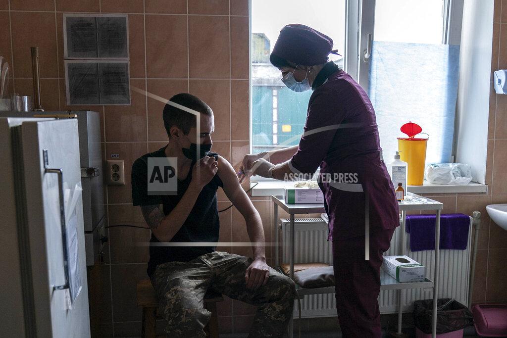 Evgeniy Maloletka A Ukrainian serviceman receives a dose of the AstraZeneca COVID-19 vaccine marketed under the name CoviShield at a military base in Kramatorsk, Ukraine, Tuesday, March 2, 2021. Ukraine plans to vaccinate 14.4 million people this year, or about 35% of its 41 million people. (AP Photo/Evgeniy Maloletka)