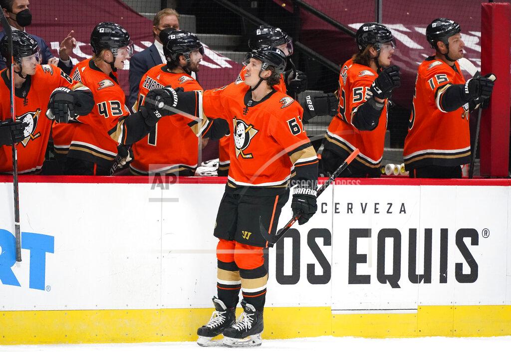 David Zalubowski FILE - In this Saturday, March 6, 2021 file photo, Anaheim Ducks center Rickard Rakell, front, is congratulated as he passes the team box after scoring a goal against the Colorado Avalanche during the first period of an NHL hockey game in Denver. Rakell is one of the few players signed beyond this season who could be moved at the NHL trade deadline. (AP Photo/David Zalubowski, File)