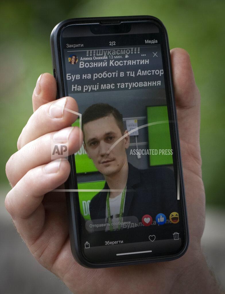 Efrem Lukatsky Oleksandr Baybuza shows a photo of his brother-in-law who was working in the shopping center during the Russian deadly rocket attack and is considered missing in Kremenchuk, Ukraine, Wednesday, June 29, 2022. Residents of the quiet, riverside city of Kremenchuk are reeling in the wake of a Russian airstrike that obliterated a shopping mall and killed at least 18. With dozens still missing, psychologists are working with families to help them through their grief and toward acceptance that they may never find their loved ones. (AP Photo/Efrem Lukatsky)