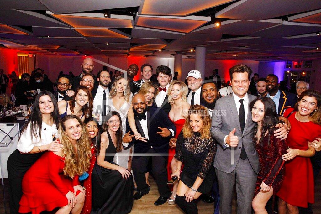 This image provided by the New York Young Republican Club, shows U.S. Rep. Matt Gaetz, R-Fla, foreground right, as he poses with attendees at the organization's 108th Annual Gala in Jersey City, N.J., on Thursday, Dec. 3, 2020. The New Jersey restaurant that hosted the political gala put on by the New York Republican Club was ordered temporarily closed Friday, Dec. 4, 2020, over potential violations of coronavirus guidelines. (Courtesy New York Republican Club via AP)