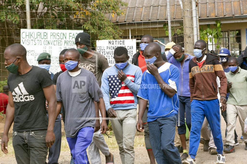 Tsvangirayi Mukwazhi Prisoners walk out of prison following their release at Chikurubi prison on the outskirts of Harare, Saturday, April 17, 2021. Zimbabwe began the release of about 3,000 prisoners under a presidential amnesty aimed at easing congestion and minimizing the threat of COVID-19 across the country's overcrowded jails. (AP Photo/Tsvangirayi Mukwazhi)
