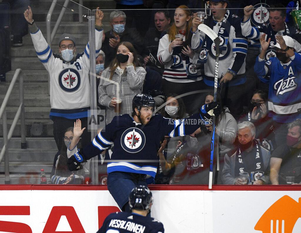 Fred Greenslade Winnipeg Jets' Adam Lowry (17) celebrates his goal against the Nashville Predators during the first period of NHL hockey game action in Winnipeg, Manitoba, Saturday, Oct. 23, 2021. (Fred Greenslade/The Canadian Press via AP)
