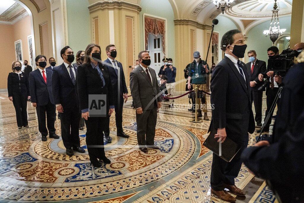 Melina Mara FILE - In this Jan. 25, 2021, file photo, Democratic House impeachment managers stand before entering the Senate Chamber as they deliver to the Senate the article of impeachment alleging incitement of insurrection against former President Donald Trump, in Washington From right to left are, Rep. Jamie Raskin, D-Md., Rep. Diana DeGette, D-Colo., Rep. David Cicilline, D-R.I., Rep. Joaquin Castro, D-Texas, Rep. Eric Swalwell, D-Calif., Rep. Ted Lieu, D-Calif., Del. Stacey Plaskett, D-Virgin Islands, Rep. Joe Neguse, D-Colo., and Rep. Madeleine Dean, D-Pa. (Melina Mara/The Washington Post via AP, Pool)