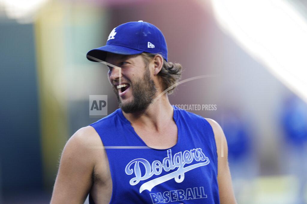 David Zalubowski Los Angeles Dodgers starting pitcher Clayton Kershaw jokes with teammates as they warm up before a baseball game against the Colorado Rockies Tuesday, Sept. 21, 2021, in Denver. (AP Photo/David Zalubowski)