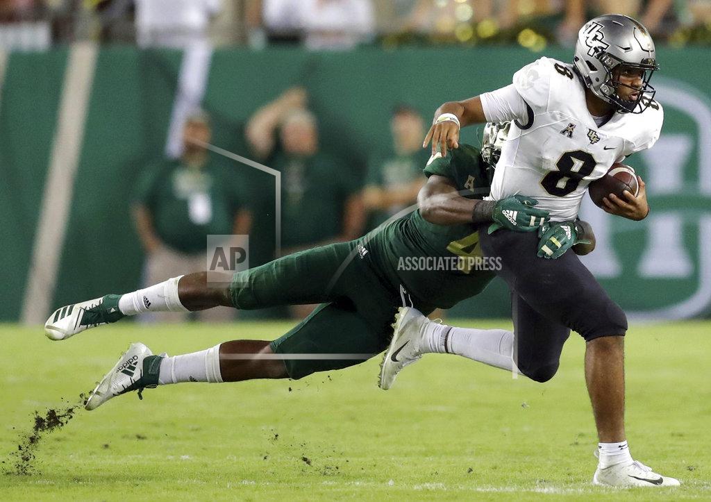Mike Carlson Central Florida's Darriel Mack Jr., right, fights off a tackle from South Florida's Greg Reaves during the second half of an NCAA college football game Friday, Nov. 23, 2018, in Tampa, Fla. (AP Photo/Mike Carlson)