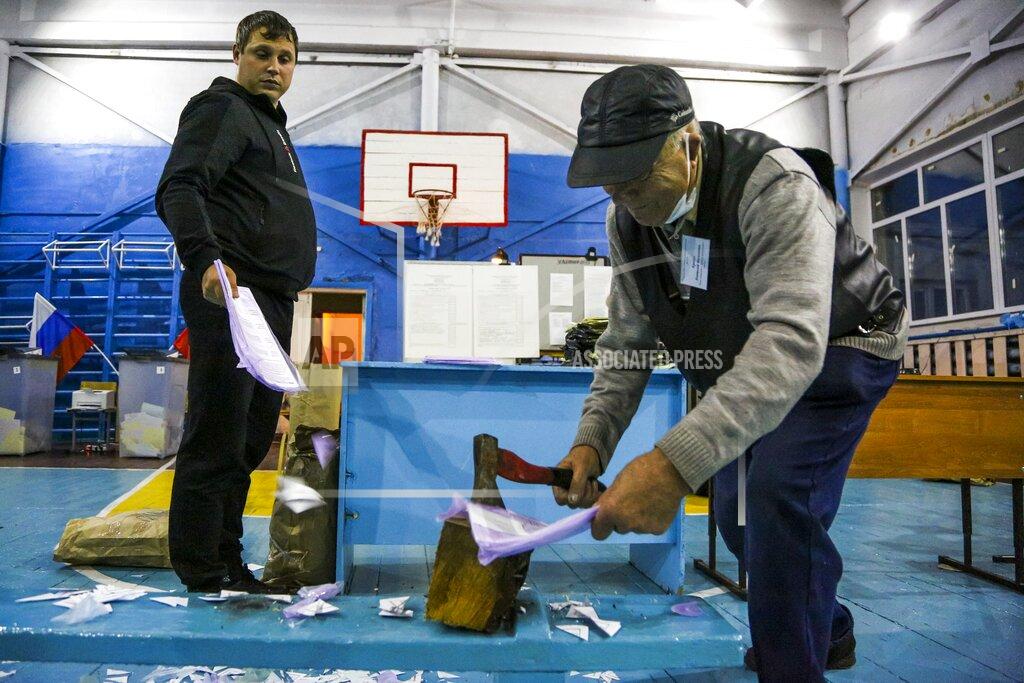 Evgeniy Sofiychuk Members of an election commission destroy unused ballots after voting at a polling station after the Parliamentary elections in Nikolayevka village outside Omsk, Russia, Sunday, Sept. 19, 2021. From the Baltic Sea to the Pacific Ocean, Russians across eleven time zones voted Sunday on the third and final day of a national election for a new parliament, a ballot in which the pro-Kremlin ruling party is largely expected to retain its majority after months of relentless crackdown on the opposition. (AP Photo/Evgeniy Sofiychuk)