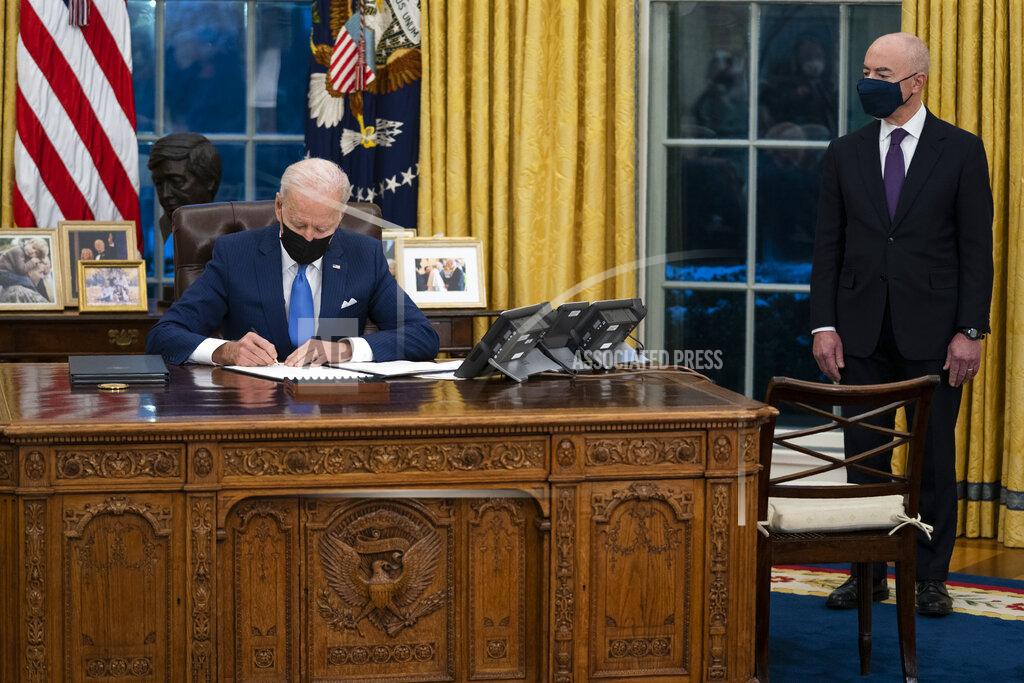 Evan Vucci Secretary of Homeland Security Alejandro Mayorkas looks on as President Joe Biden signs an executive order on immigration, in the Oval Office of the White House, Tuesday, Feb. 2, 2021, in Washington. (AP Photo/Evan Vucci)