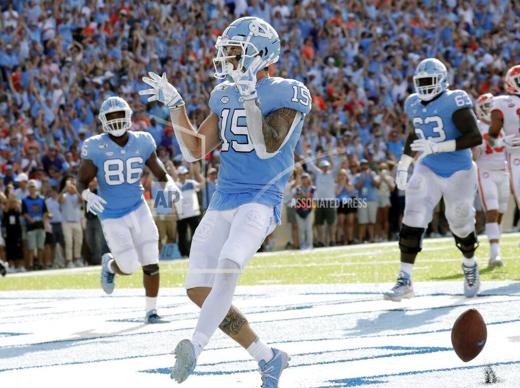 Chris Seward North Carolina's Beau Corrales (15) celebrates as he runs for a touchdown while teammates Carl Tucker (86) and Ed Montilus (63) look on during the second quarter of an NCAA college football game against Clemson in Chapel Hill, N.C., Saturday, Sept. 28, 2019. (AP Photo/Chris Seward)