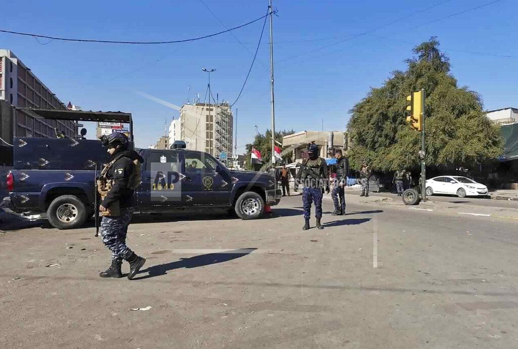 Hadi Mizban Security forces gather at the site of a deadly bomb attack in Baghdad's bustling commercial area, Iraq, Thursday, Jan. 21, 2021. Twin suicide bombings hit Iraq's capital Thursday killing and wounding civilians, police and state TV said. (AP Photo/Hadi Mizban)
