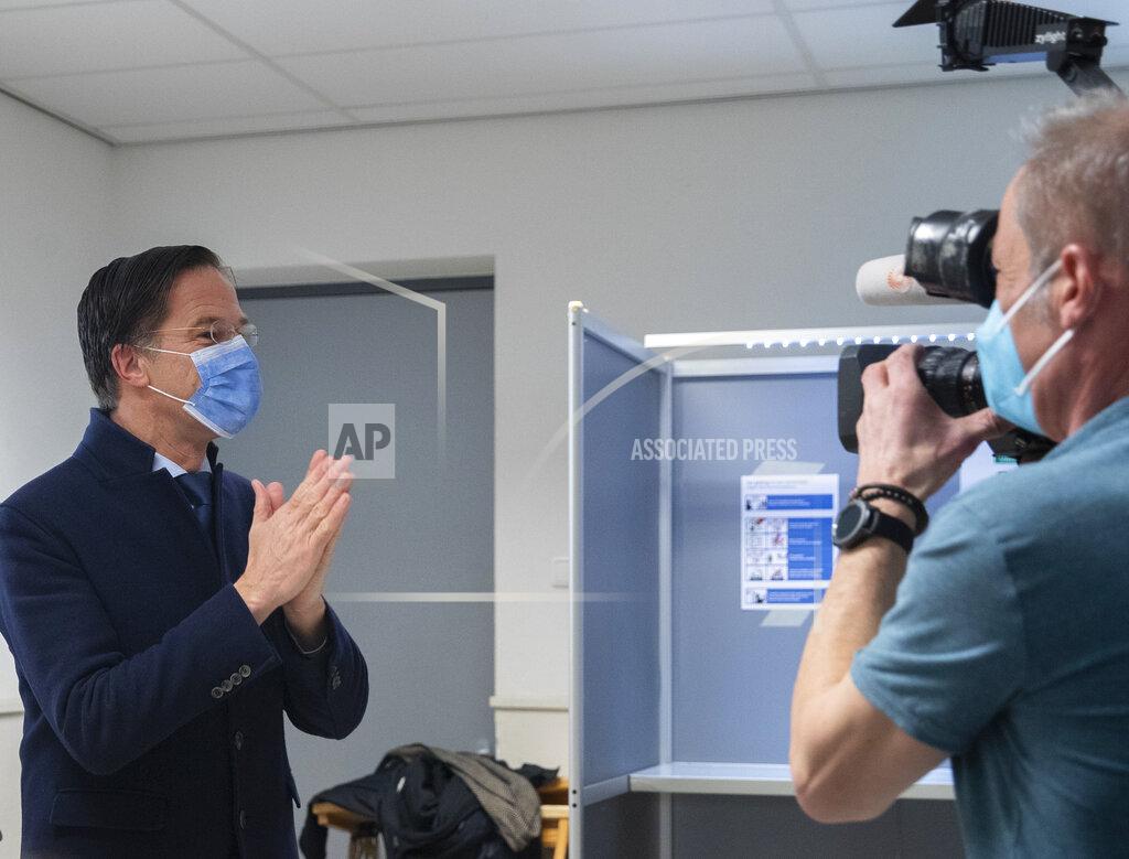 Peter Dejong Dutch caretaker Prime Minster Mark Rutte thanked election officials after casting his vote in a general election in The Hague, Wednesday, March 17, 2021. Polling stations have opened opened across the Netherlands from Monday in a general election that has been spread over three days to allow people to vote safely during the coronavirus pandemic. (AP Photo/Peter Dejong, Pool)