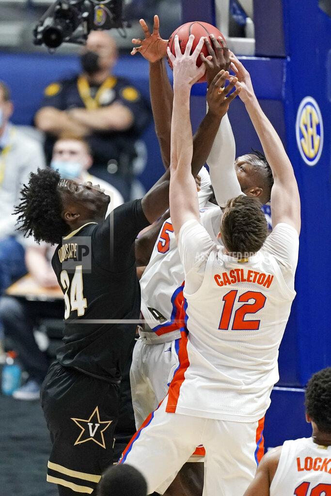 Mark Humphrey Vanderbilt's Akeem Odusipe (34) reaches for a rebound with Florida's Colin Castleton (12) in the first half of an NCAA college basketball game in the Southeastern Conference Tournament Thursday, March 11, 2021, in Nashville, Tenn. (AP Photo/Mark Humphrey)