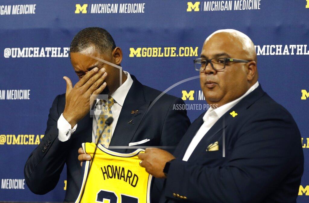 Juwan Howard reacts with tears of joys as he is introduced as Michigan's new men's NCAA college basketball coach by Director of Athletics Warde Manuel, Thursday, May 30, 2019 in Ann Arbor, Mich. The former member of the Fab Five has a five-year contract that will pay him $2 million in his first year. The former Miami Heat assistant coach replaces John Beilein, who left to coach the Cleveland Cavaliers. (AP Photo/Carlos Osorio)