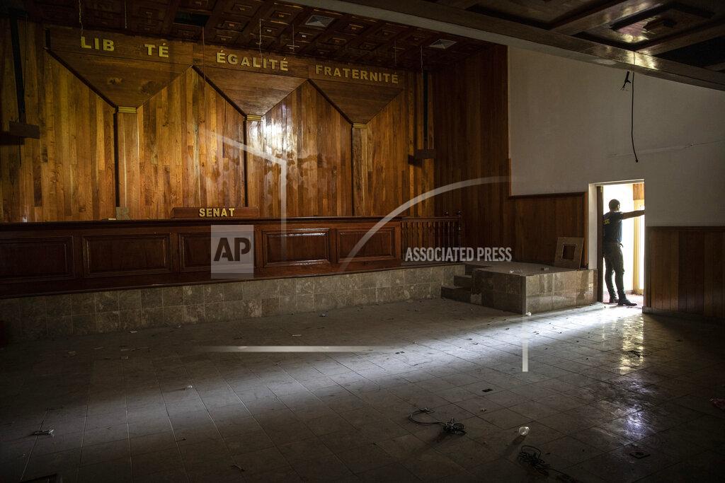 Rodrigo Abd A policeman stands in the entrance of the deserted Senate chambers, inactive for over a year, in Port-au-Prince, Haiti, Tuesday, Sept. 22, 2021. The country has struggled with political instability — along with dire poverty and crime — since the end of the brutal dictatorships of Francois and Jean-Claude Duvalier from 1957 to 1986. (AP Photo/Rodrigo Abd)