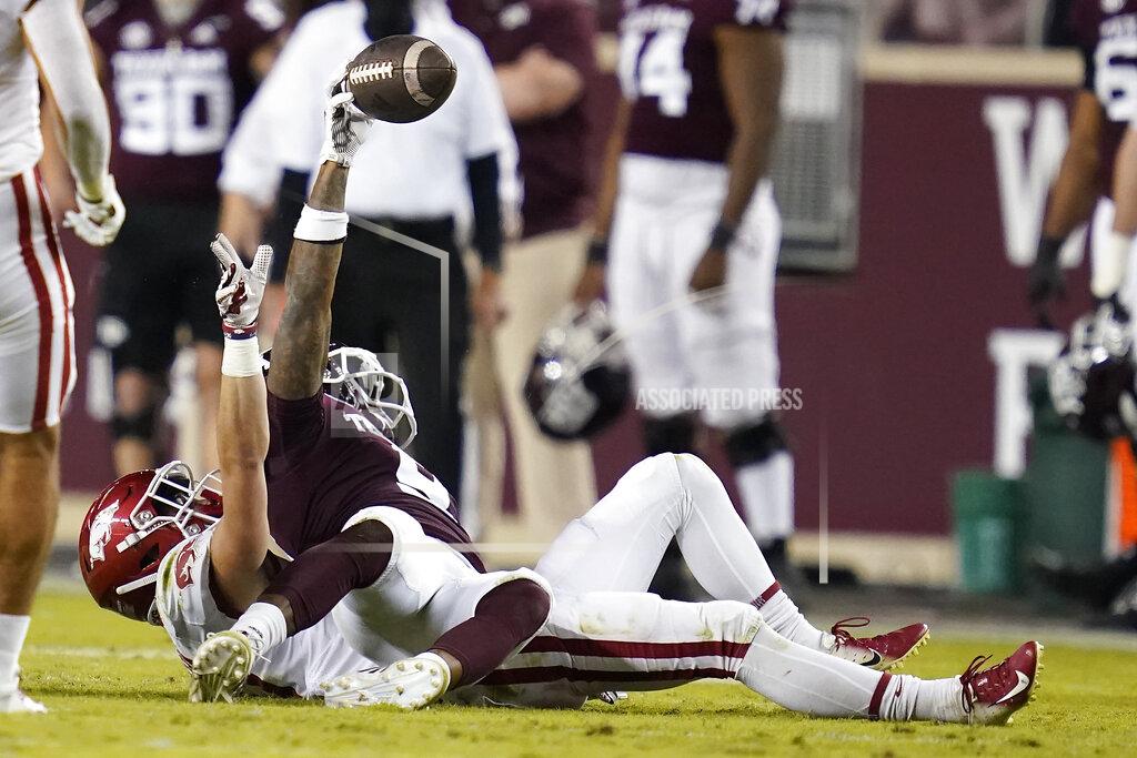 Sam Craft Texas A&M wide receiver Hezekiah Jones (9) reacts after a catch, and being tackled by Arkansas defensive back Hudson Clark (17) during the second quarter of an NCAA college football game Saturday, Oct. 31, 2020, in College Station, Texas. (AP Photo/Sam Craft)
