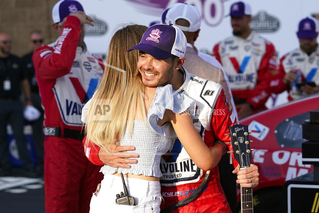 Mark Humphrey Kyle Larson hugs his wife, Katelyn Sweet, after winning a NASCAR Cup Series auto race Sunday, June 20, 2021, in Lebanon, Tenn. (AP Photo/Mark Humphrey)