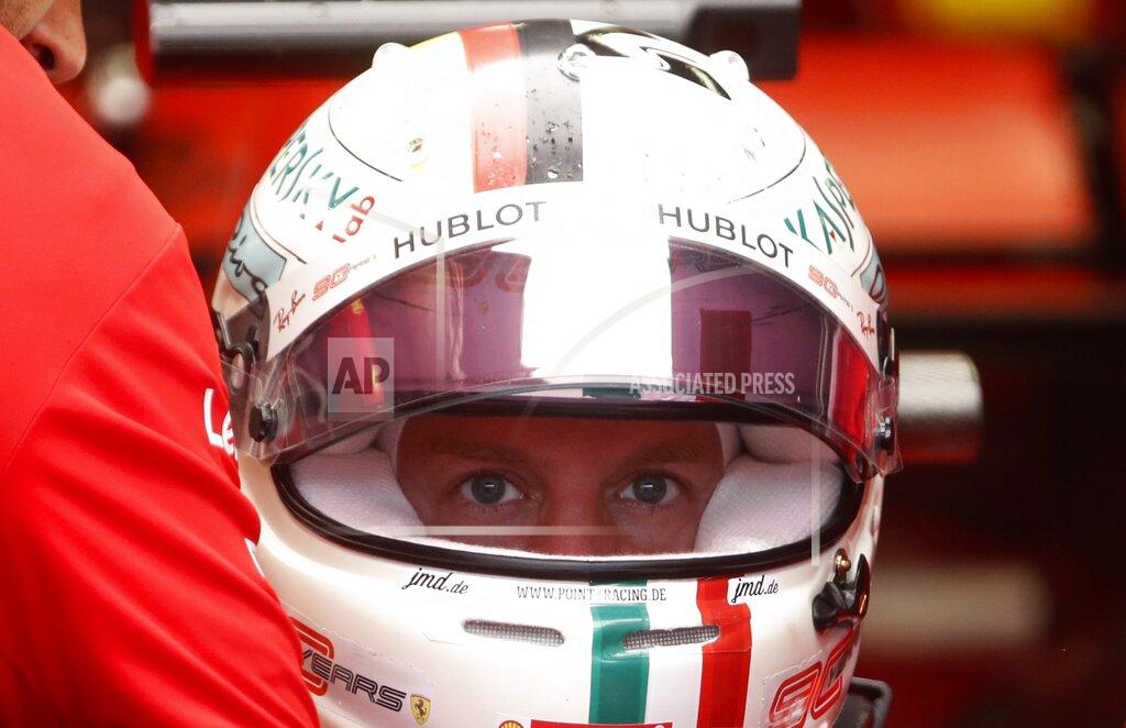 Antonio Calanni Ferrari driver Sebastian Vettel of Germany gets in his car during the first free practice at the Monza racetrack, in Monza, Italy, Friday, Sept. 6, 2019. The Formula one race will be held on Sunday. (AP Photo/Antonio Calanni)