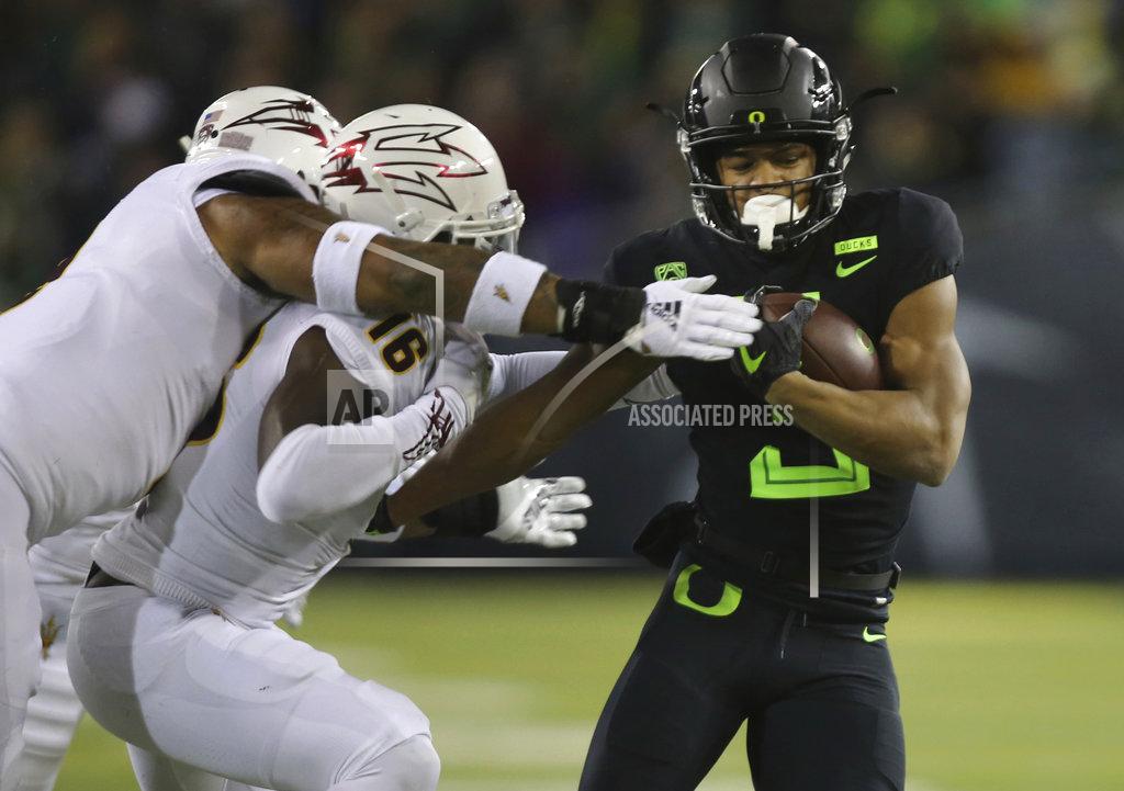 Chris Pietsch Oregon's Johnny Johnson III, right, is tackled by Arizona State's Jay Jay Wilson, left, and Aashari Crosswell during the second quarter of an NCAA college football game Saturday, Nov. 17, 2018, in Eugene, Ore. (AP Photo/Chris Pietsch)