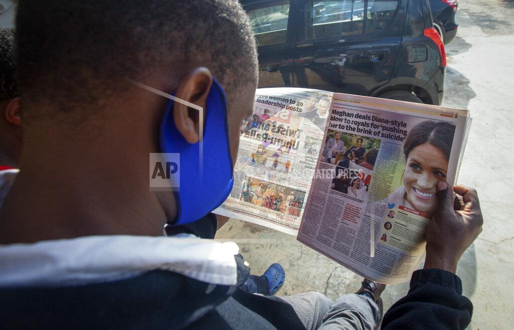 Sayyid Abdul Azim A man reads a copy of The Standard newspaper with coverage of the two-hour appearance of Britain's Prince Harry and Meghan with Oprah Winfrey, in Nairobi, Kenya Tuesday, March 9, 2021. Prince Harry and Meghan's explosive TV interview divided people around the world on Monday, rocking an institution that is struggling to modernize with claims of racism and callousness toward a woman struggling with suicidal thoughts. (AP Photo/Sayyid Abdul Azim)