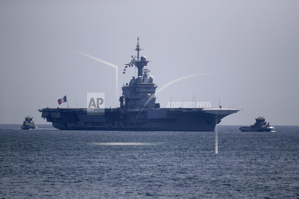 Daniel Cole The French aircraft carrier Charles de Gaulle arrives in the bay of Toulon, southern France, Sunday April 12, 2020. The Defense Ministry said in a statement that around 40 sailors showed symptoms compatible with COVID-19, the disease the coronavirus causes. The new coronavirus causes mild or moderate symptoms for most people, but for some, especially older adults and people with existing health problems, it can cause more severe illness or death. (AP Photo/Daniel Cole)