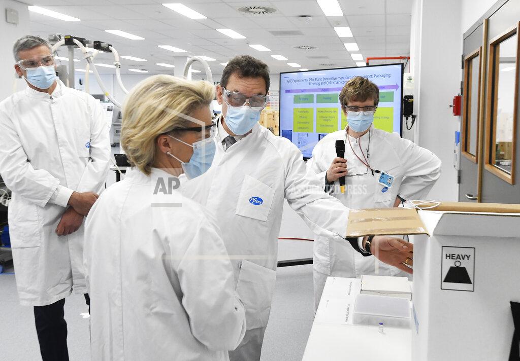 FILE - In this Friday, April 23, 2021 file photo, European Commission President Ursula von der Leyen, second left, speaks with Pfizer CEO Albert Bourla, center right, during an official visit to the Pfizer pharmaceutical company in Puurs, Belgium. The European Union cemented its support for Pfizer-BioNTech and its novel COVID-19 vaccine technology on Saturday, May 8, 2021 by agreeing to a massive contract extension for a potential 1.8 billion doses through 2023. The new contract, which has the backing of the EU member states, will entail not only the production of the vaccines, but also making sure that all the essential components should be sourced from the EU. (John Thys/Pool via AP, File)