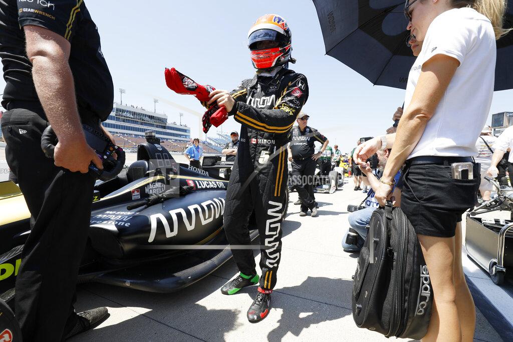 Charlie Neibergall FILE - In this July 19, 2019, file photo, James Hinchcliffe stands next to his car during qualifying for the IndyCar Series auto race at Iowa Speedway in Newton, Iowa. McLaren will return to full-time IndyCar competition next season for the first time since 1979 in a partnership with existing team Arrow Schmidt Peterson Motorsports. The new venture will be renamed Arrow McLaren Racing SP and rely on Arrow SPM's current infrastructure.(AP Photo/Charlie Neibergall, File)