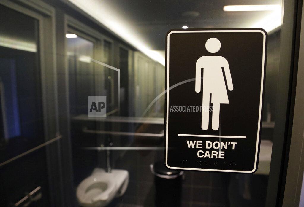 Gerry Broome FILE - In this May 12, 2016, file photo, gender free sign hangs outside a restroom at 21c Museum Hotel in Durham, N.C. A 3 1/2-year ban on local ordinances aimed at protecting LGBT rights in North Carolina expired Tuesday, Dec. 1, 2020, prompting gay rights groups to urge the passage of such measures.
Democratic Gov. Roy Cooper agreed to the moratorium in March 2017 in exchange for GOP lawmakers agreeing to do away with portions of a “Bathroom Bill” that Republicans had approved a year earlier.(AP Photo/Gerry Broome, File)