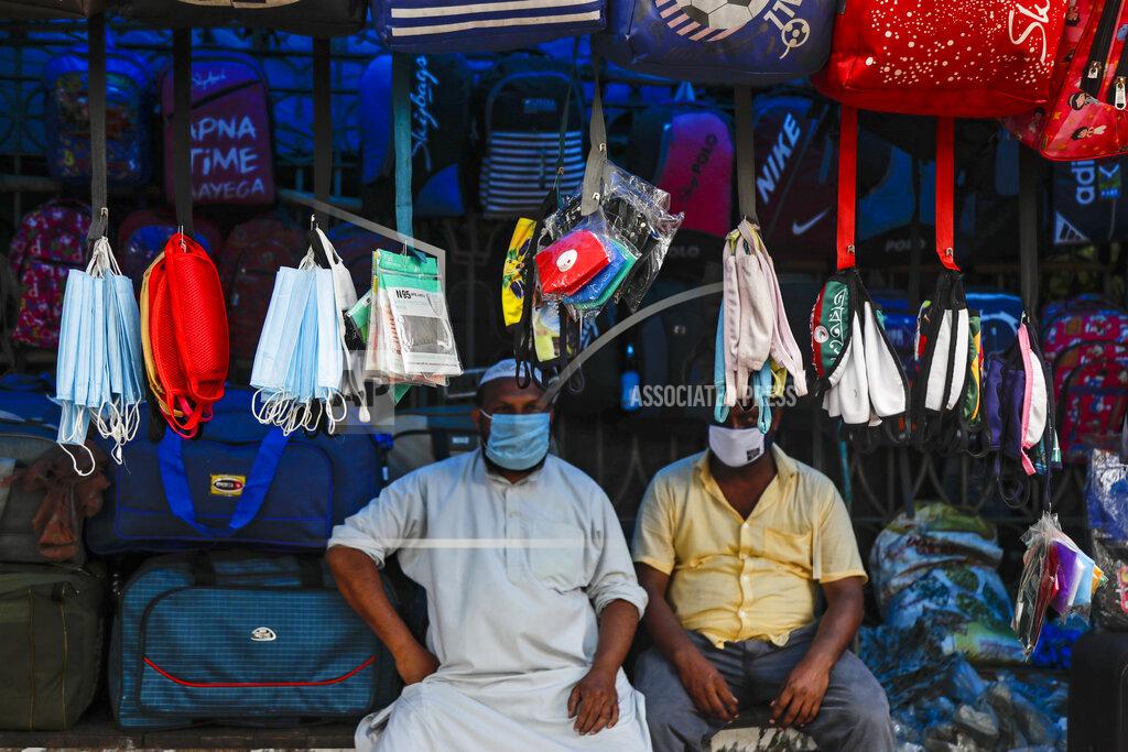 Bikas Das Face masks hang at a roadside stall for sale in Kolkata, India, Friday, Aug. 14, 2020. India's coronavirus death toll overtook Britain's to become the fourth-highest in the world with another single-day record increase in cases Friday. (AP Photo/Bikas Das)