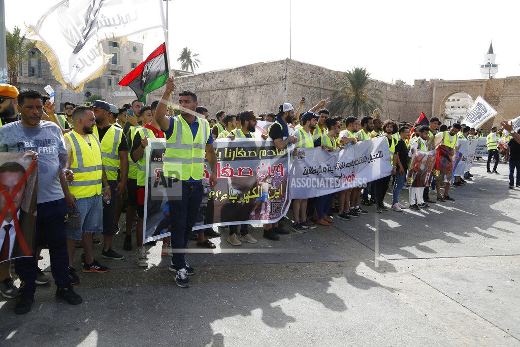 Yousef Murad Protesters demonstrate in Martyrs Square in Tripoli, Libya, Friday, July 1, 2022, calling for election and protesting against the government and parliament. (AP Photo/Yousef Murad)