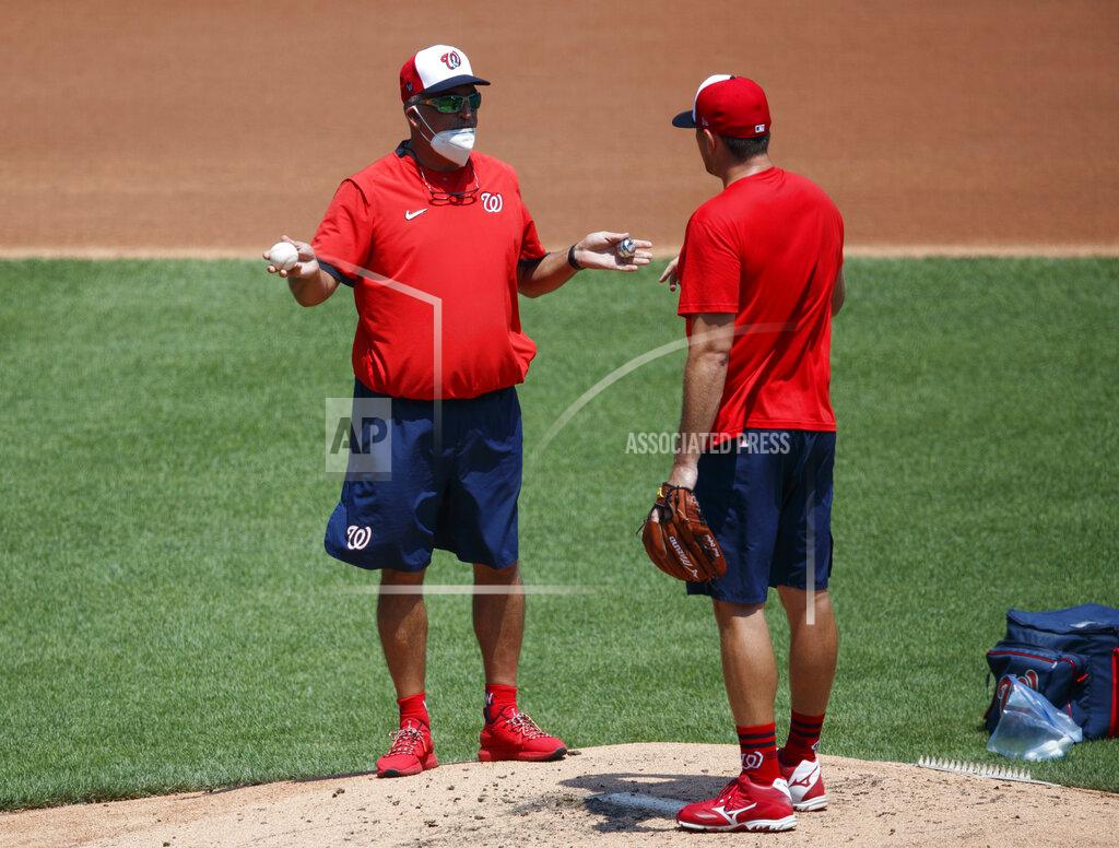 Carolyn Kaster Washington Nationals' pitching coach Paul Menhart, left, talks with pitcher Daniel Hudson on the mound during a baseball training camp workout at Nationals Stadium, Sunday, July 5, 2020, in Washington. (AP Photo/Carolyn Kaster)