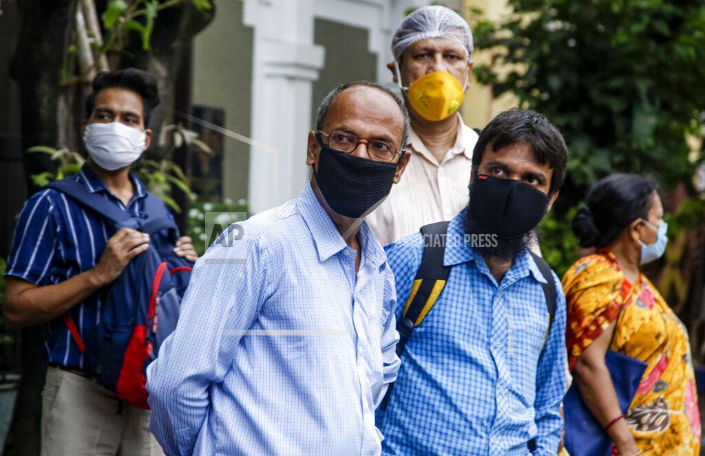 Bikas Das Commuters with face mask as a precaution against the coronavirus wait for a bus in Kolkata, India, Thursday, July 9, 2020. India has overtaken Russia to become the third worst-affected nation by the coronavirus pandemic. (AP Photo/Bikas Das)