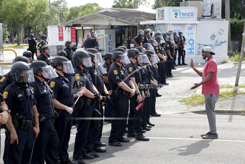 Douglas R. Clifford A protester speaks to a line of Tampa, Fla., police officers who were securing a location during a demonstration Sunday, May 31, 2020, against the death of George Floyd and others. Floyd died May 25 after he was pinned at the neck by a Minneapolis police officer. (Douglas R. Clifford/Tampa Bay Times via AP)