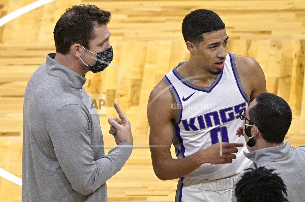Phelan M. Ebenhack Sacramento Kings coach Luke Walton, left, talks to guard Tyrese Haliburton (0) during a timeout in the second half of the team's NBA basketball game against the Orlando Magic, Wednesday, Jan. 27, 2021, in Orlando, Fla. (AP Photo/Phelan M. Ebenhack)