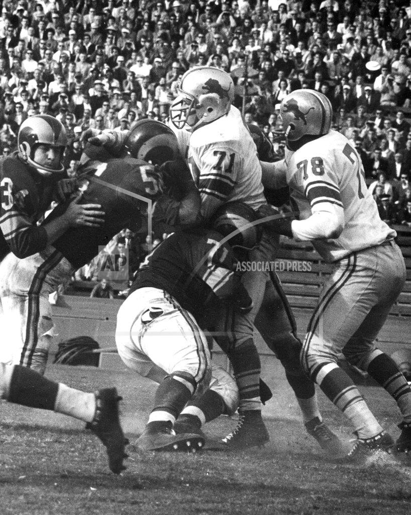 Uncredited FILE- In this undated file photo, unidentified members of the Los Angeles Rams NFL football team try and stop Detroit Lions defensive tackle Alex Karras (71) during a game in Michigan. For all the acclaim that followed, Karras died at age 77 in 2012 without one of the honors he coveted most: a bust in the Pro Football Hall of Fame.
Better late than never, Karras will be formally enshrined as part of the Hall’s Centennial Class of 2020. (Detroit Lions via AP)